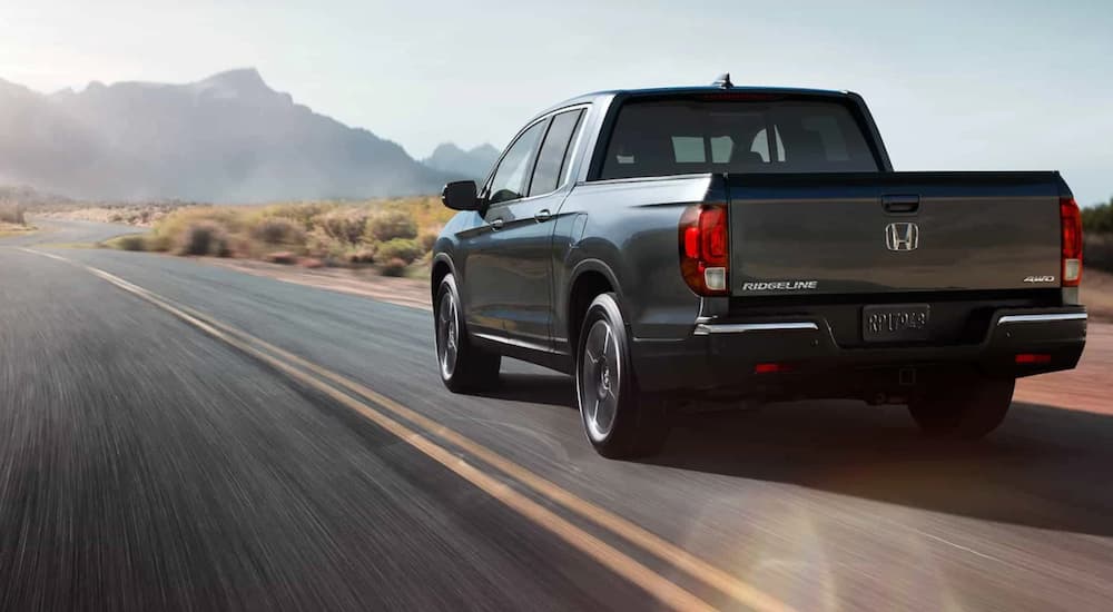 A grey 2017 Honda Ridgeline is shown from the rear at an angle.