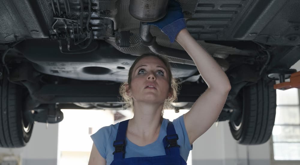 A technician under a vehicle.