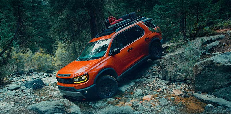 An orange 2026 Honda Passport off-roading.