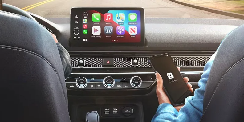an individual connecting their phone to the infotainment system in a 2024 Honda Civic Sedan.