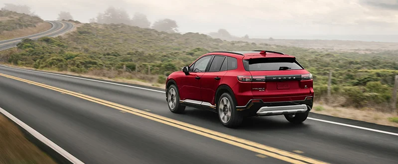 A photo of a red 2025 Honda Prologue driving down the road.