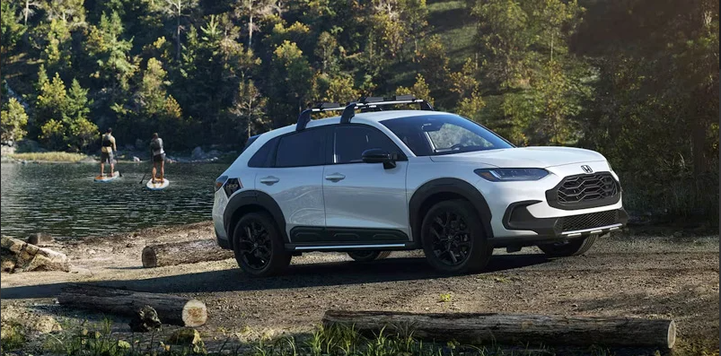 A photo of a white 2025 Honda HR_V parked by a lake.