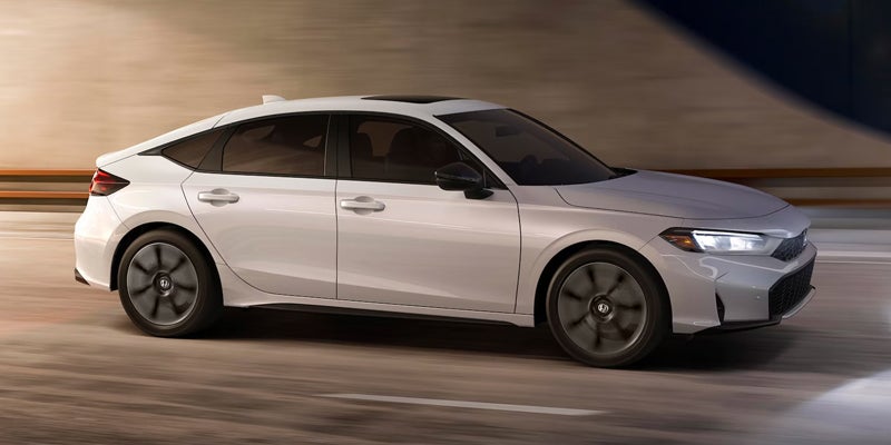 2026 White Honda Civic Hatchback cruising in dark with it's stunning looks