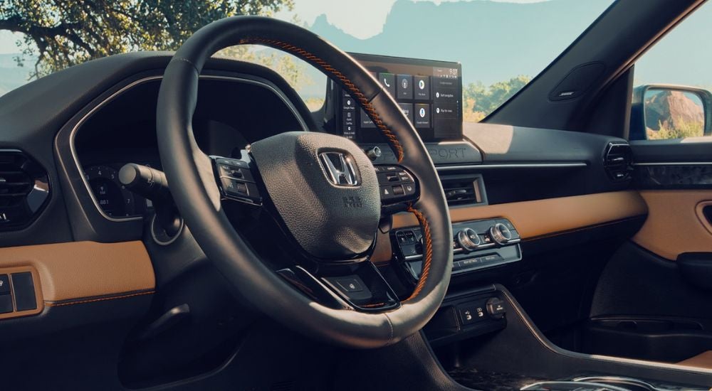 Black and brown interior of a 2027 Honda Passport TrailSport Elite.