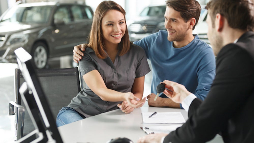 Couple getting new car keys