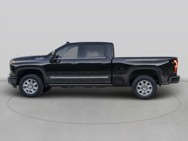 The left side of a Chevrolet truck parked inside