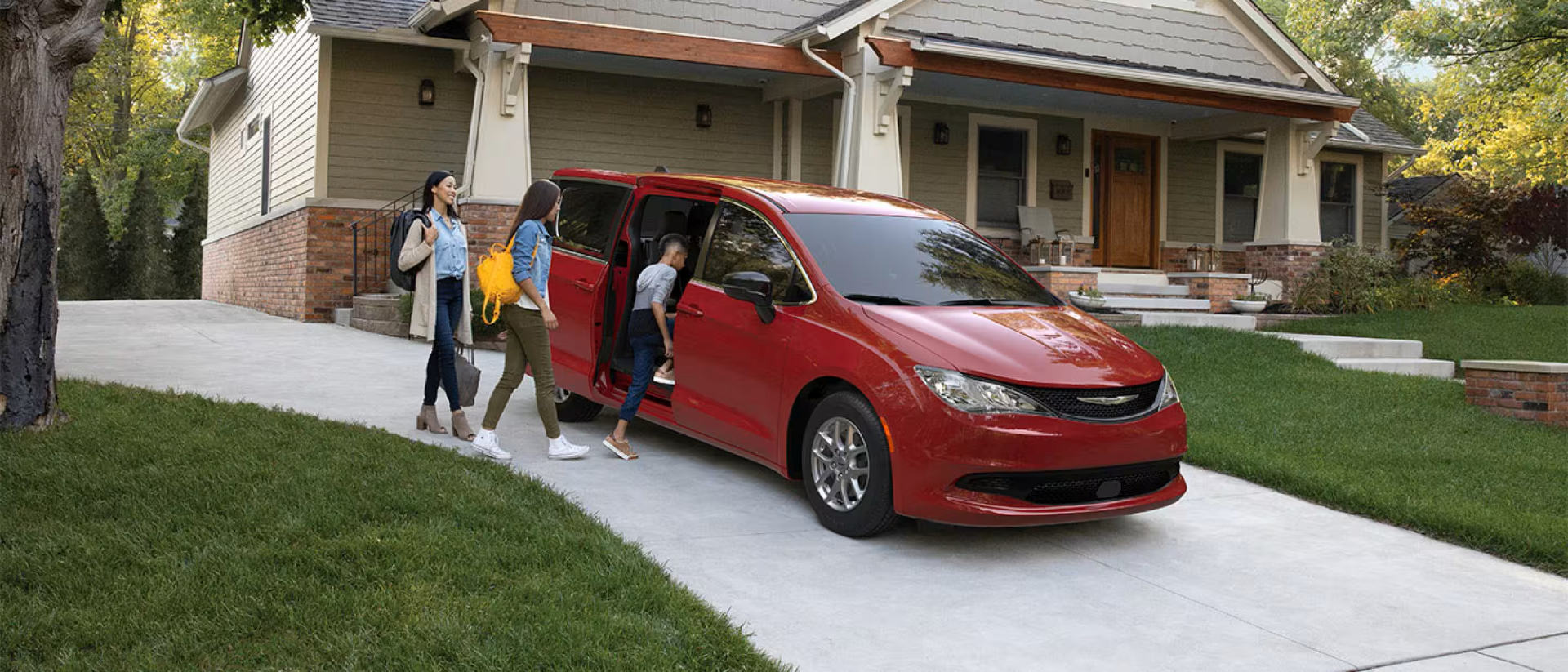 2026 Chrysler Voyager parked in the driveway with family