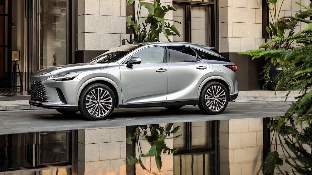 A silver 2026 Lexus RX parked next to a reflecting pool