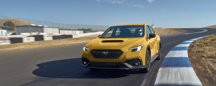 2026 Subaru WRX Series.Yellow in Sunrise Yellow, featuring Black Ultrasuede® seat inserts with black bolsters and yellow contrast stitching, shown in action.