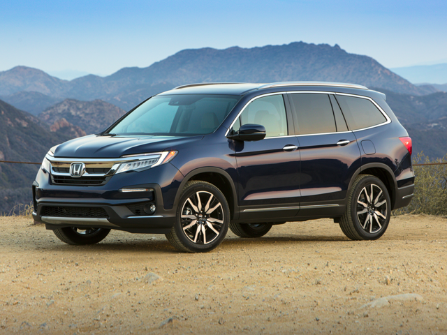 A photo of a black 2019 Honda pilot parked on a mountaintop