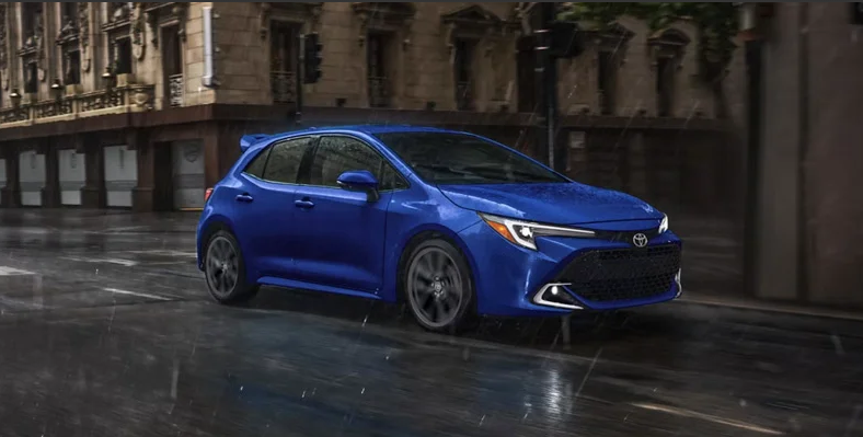 A 2026 Toyota Corolla Hatchback driving down the road.