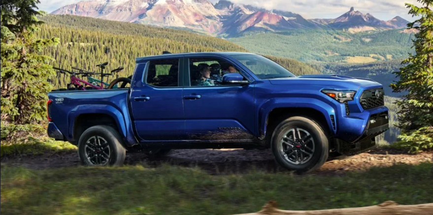 A blue 2024 Toyota Tacoma off roading near Woodrum Toyota of Macomb.