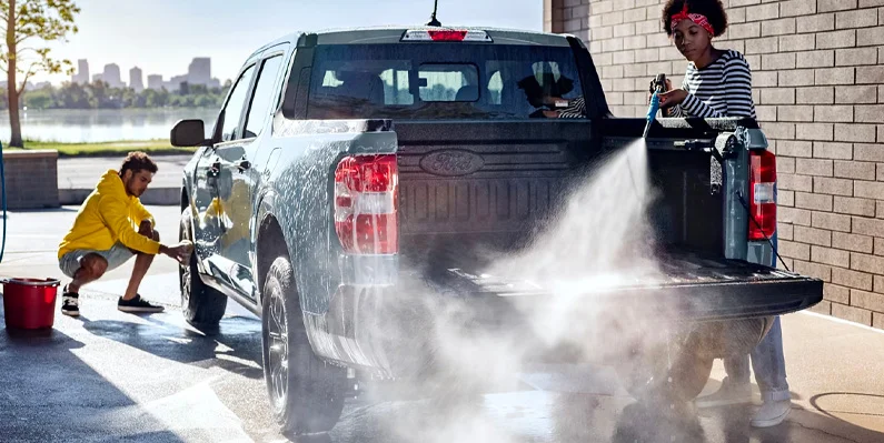 Two individuals washing the 2025 Ford Maverick.