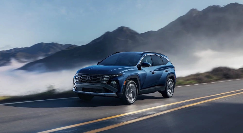 A blue 2025 Hyundai Tucson Limited is shown from the front at an angle after leaving a Hyundai dealer near Barrington.