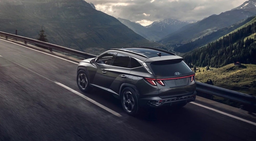 A grey 2022 Hyundai Tucson is shown from the rear at an angle after leaving a used Hyundai dealer.