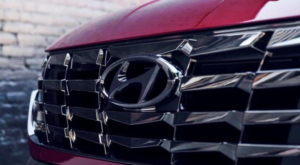 A close up shows the grille on a red 2023 Hyundai Tucson N-Line.