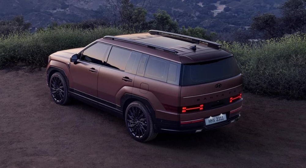A purple 2024 Hyundai Santa Fe is shown from a high angle.