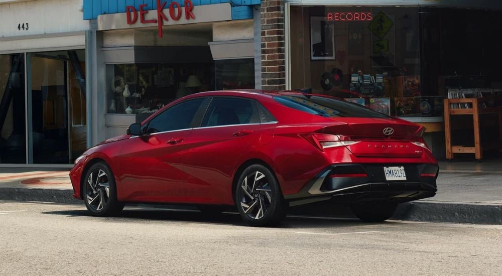 A red 2024 Hyundai Elantra is shown from the rear at an angle.