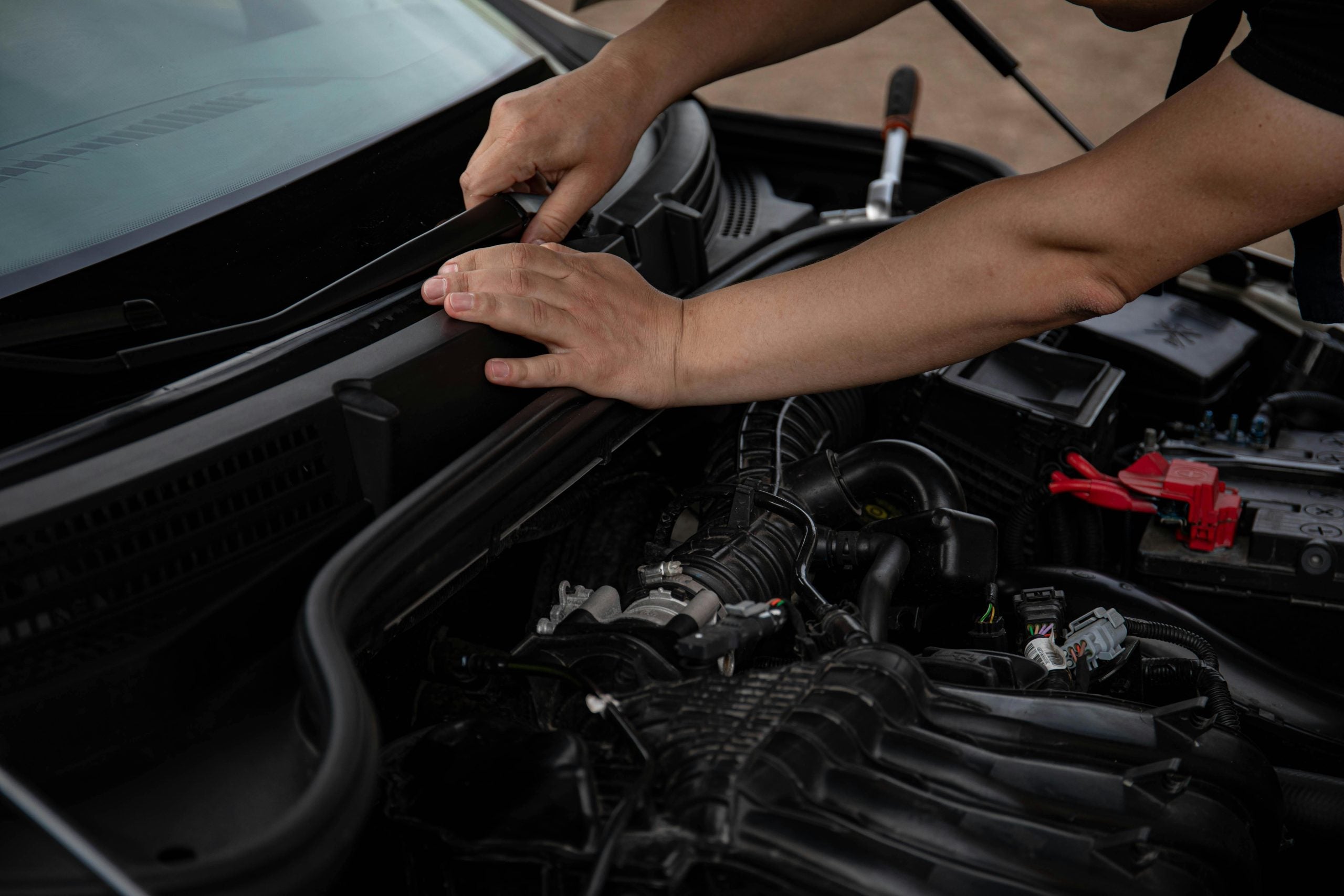 A mechanic installing windshield wipers