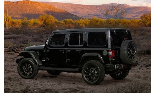 2020 Jeep Wrangler High Altitude exterior side shot with black paint color parked in a desert wilderness as the sun sets