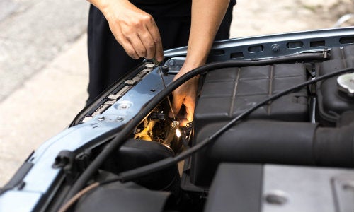 a service center working repairing and replacing an old vehicle headlight
