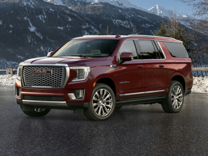 2024 GMC Yukon XL in front of a mountain.