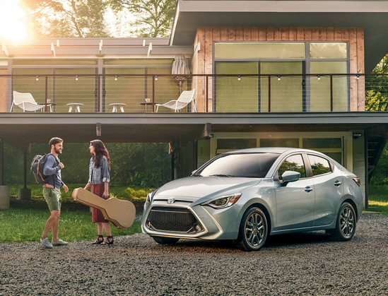 Silver Toyota model in front of a home