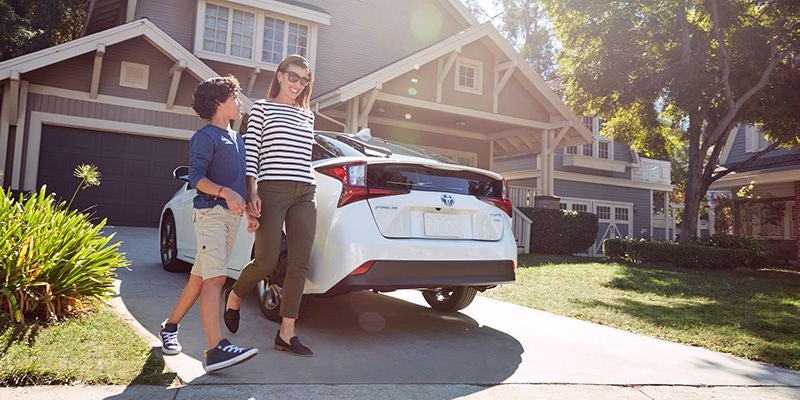 2020 White Toyota Prius in front of home