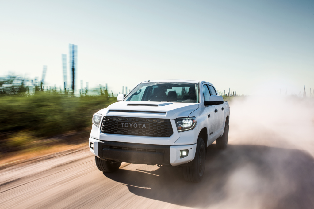 White Toyota TRD Pro Series model driving on dirt road