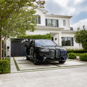 2024 BMW iX Charging in a driveway.