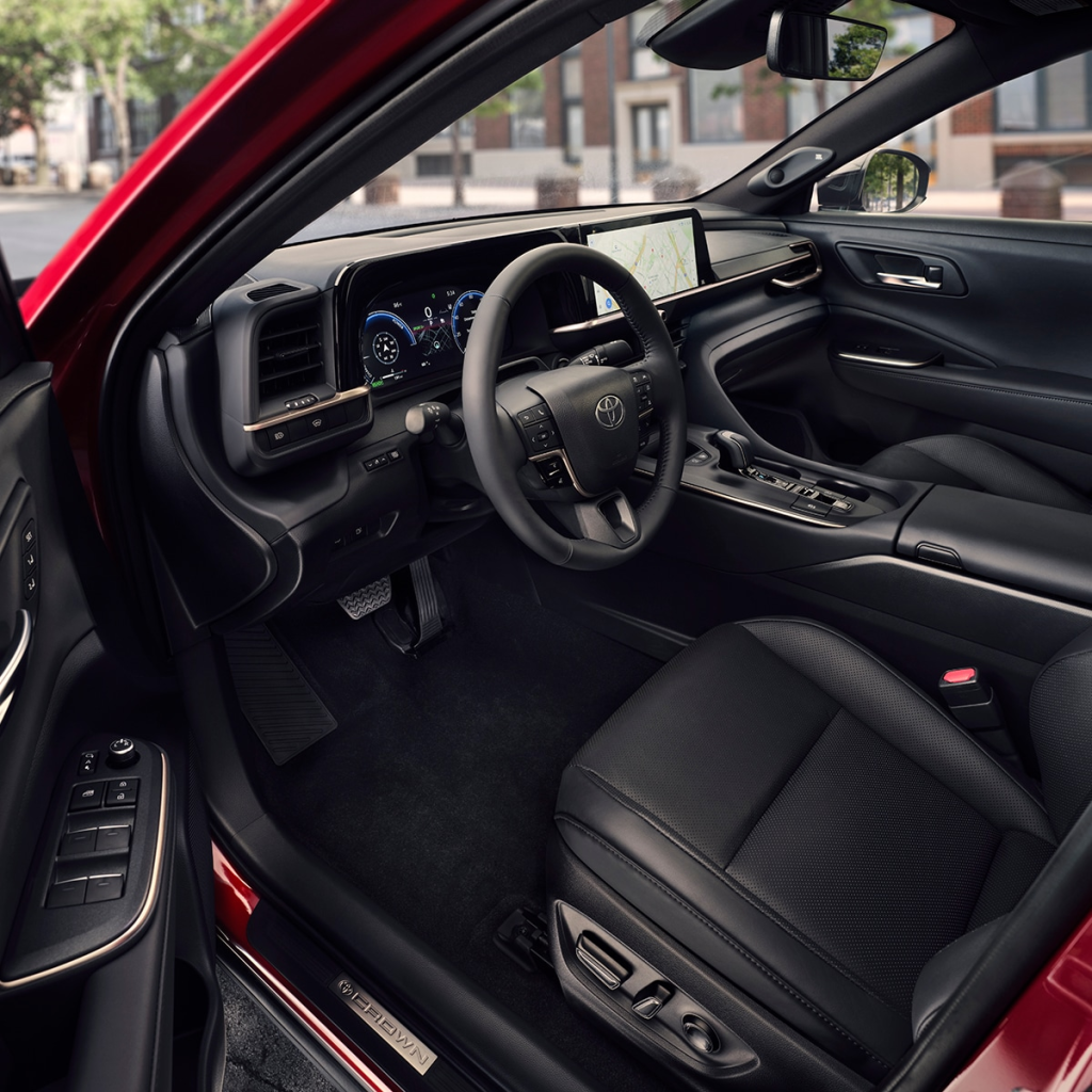 Interior of a red car featuring a sleek, modern design. Black leather seats, touchscreen display, and digital dashboard create a tech-savvy, luxurious feel.