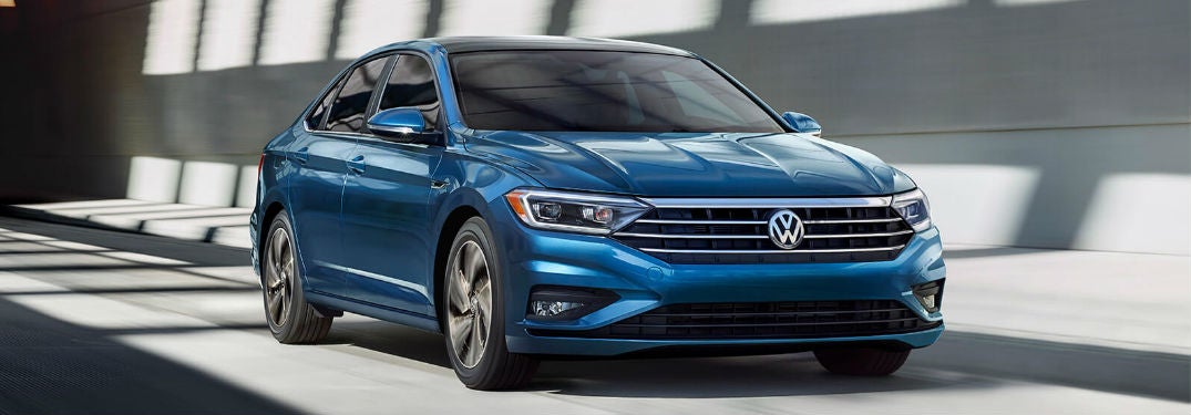 Volkswagen Jetta driving on a road