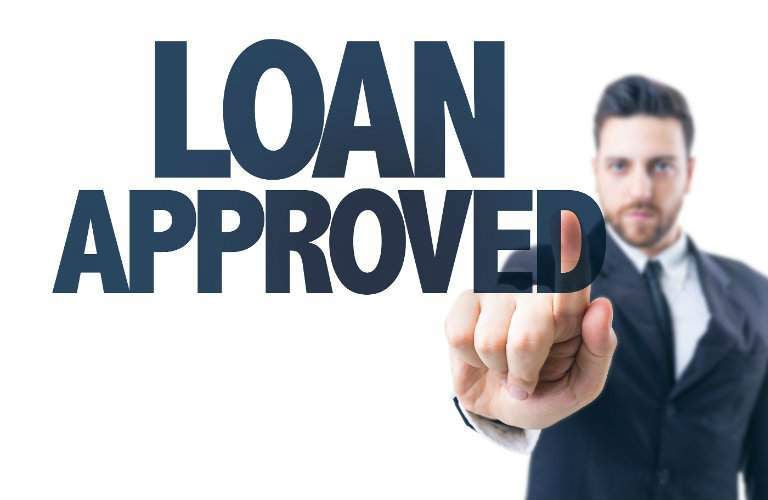 Loan approved text with man standing in the background