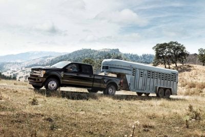 2017 Ford F-150 towing a trailer through a field