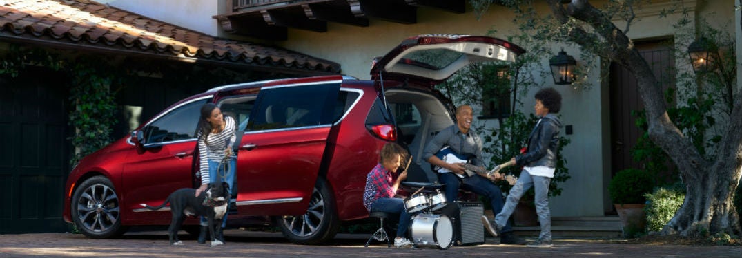Chrysler Pacifica parked in a driveway with rear liftgate up