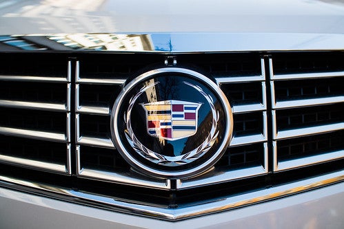 Close-up of Cadillac emblem on a white Cadillac vehicle