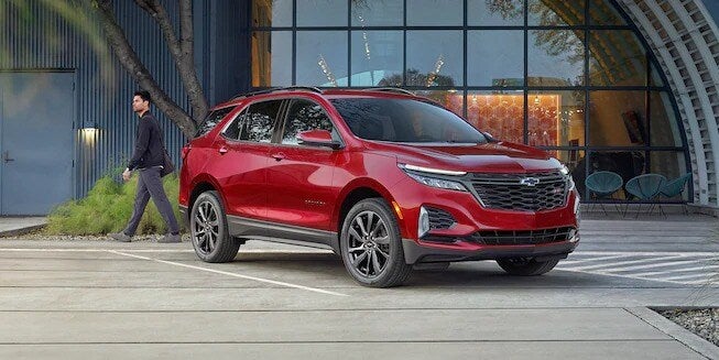 A red 2022 Chevrolet Equinox parked on a street