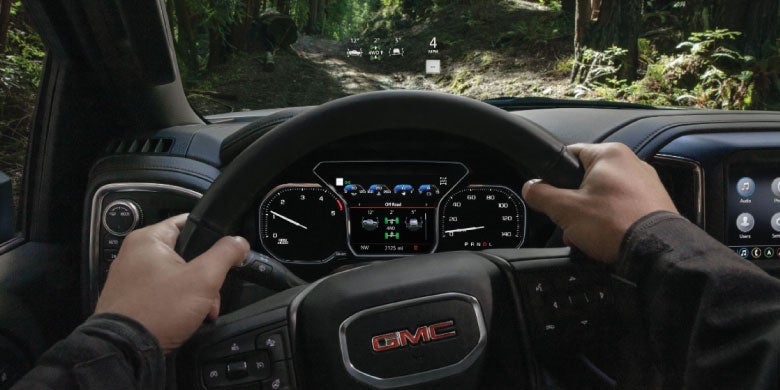 2026 GMC Terrain driver’s view of steering wheel and dashboard.