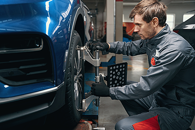 Service tech checking wheel alignment
