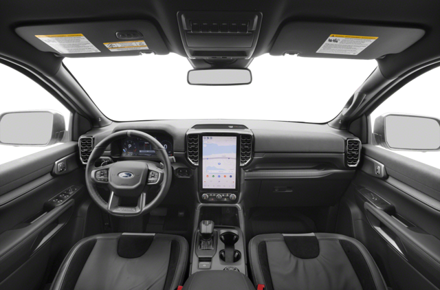 A driver's view of a car's black and gray interior, centered on the steering wheel and large touchscreen.
