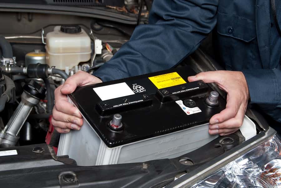 a car battery under the hood.