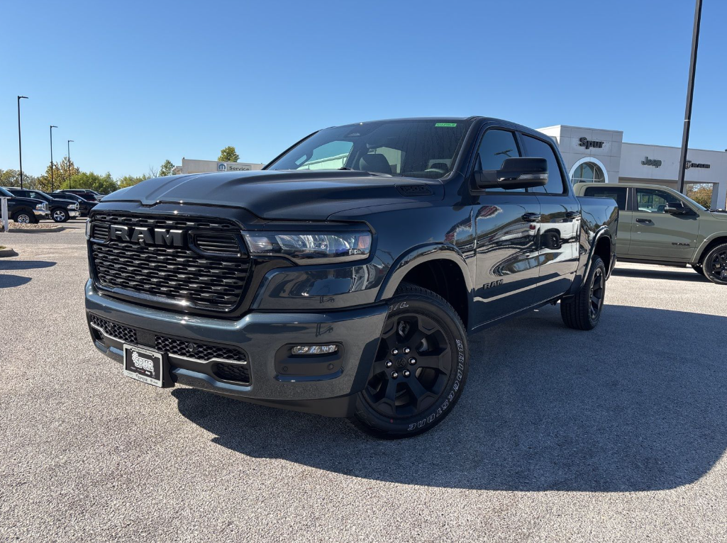 2026 Ram 1500 with a bold front grille, shown outside Spur Chrysler Dodge Jeep RAM in Gatesville, TX