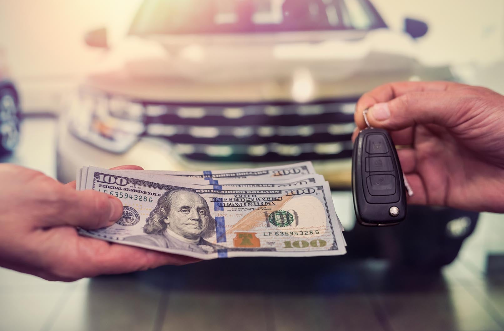 purchase deal of buy or rent new car. Hand with dollar money and