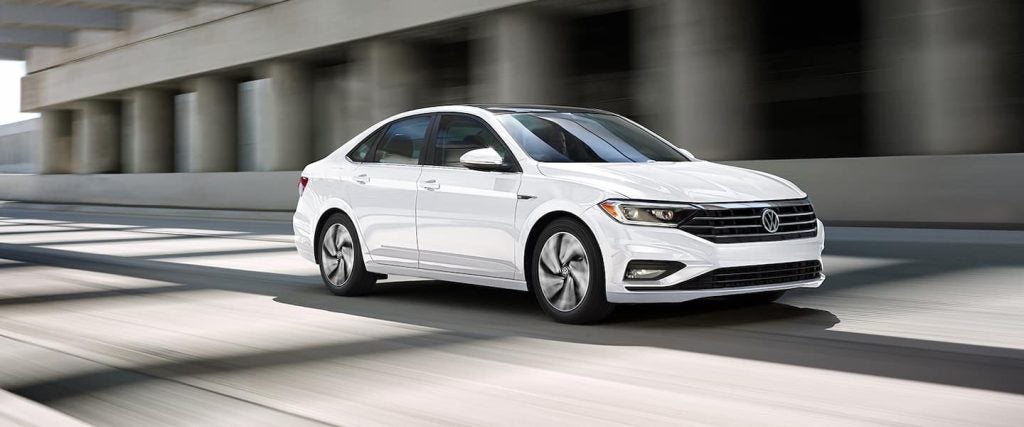2020 White Jetta driving on the road 