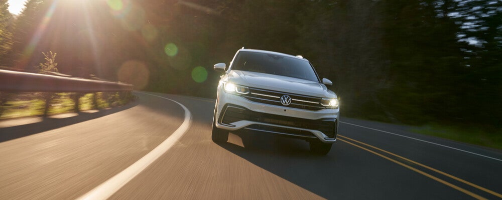 a silver volkswagen speeding down the highway 