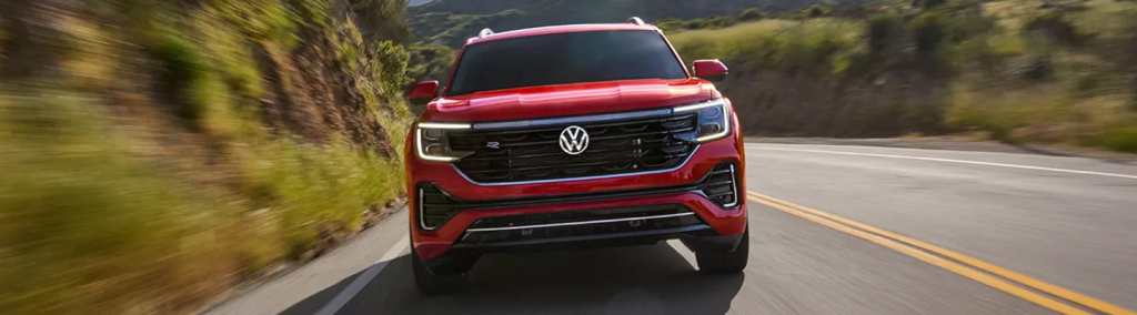 A red volkswagen atlas speeding towards the camera 