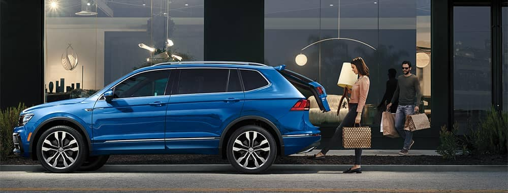 Couple-loading-things-into-cargo-of-Volkswagen-Tiguan-