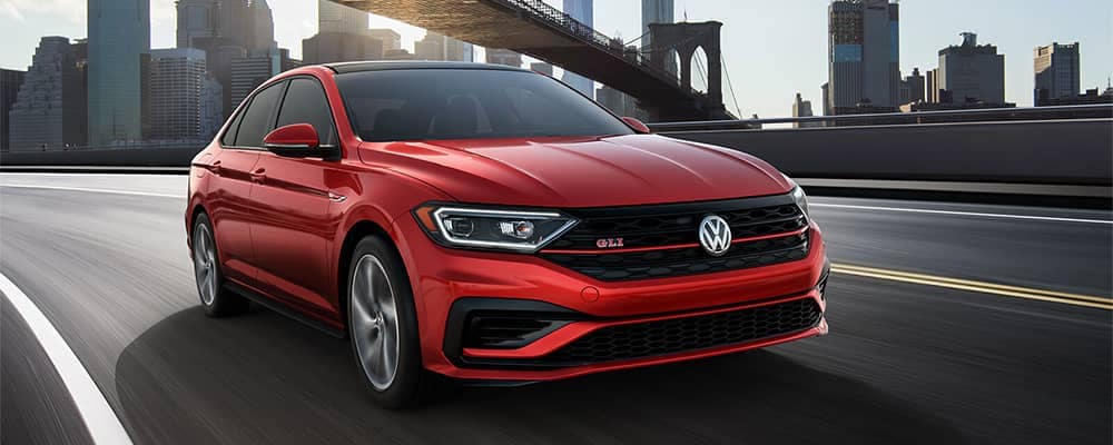 A red jetta gli driving along the highway 