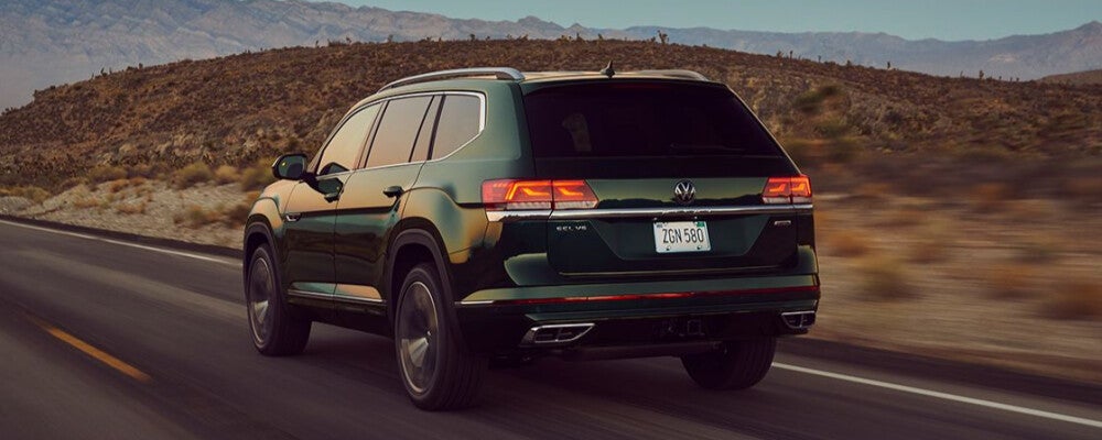 a green volkswagen driving on a highway 