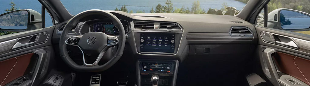 leather interior of a volkswagen tiguan with a black wheel and dashboard 